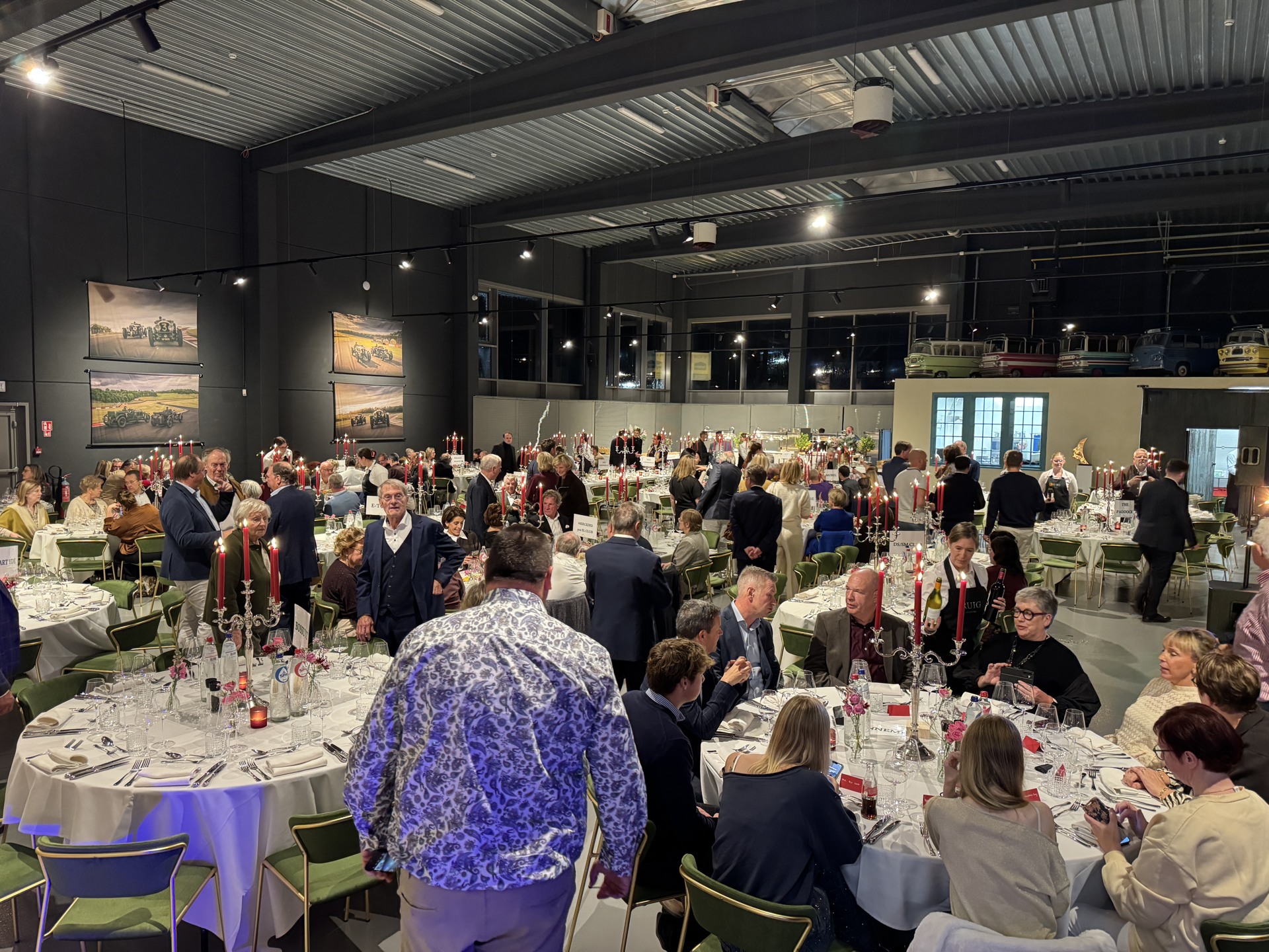 Guests at candlelit dinner tables