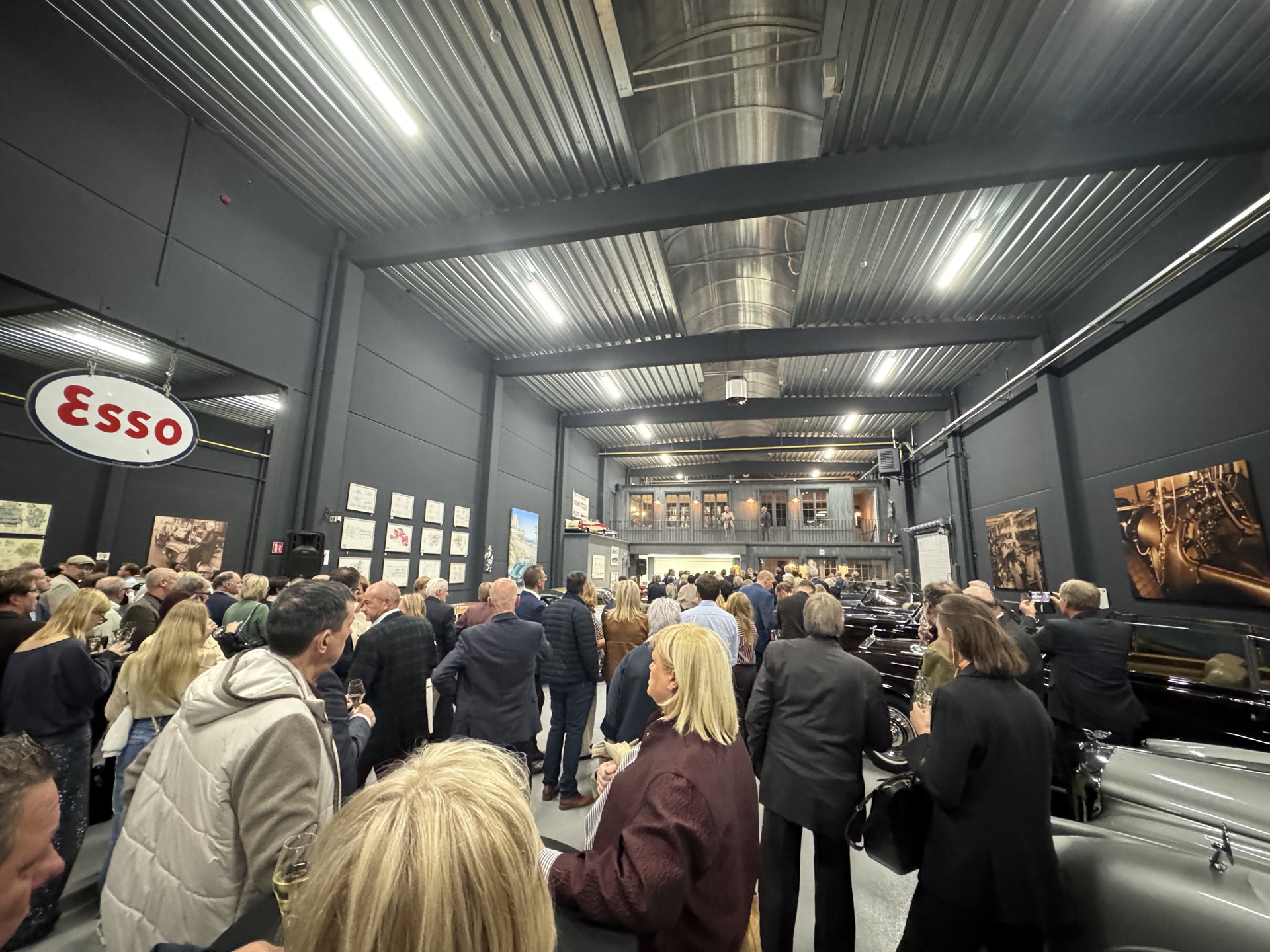Guests gathered between historic cars during the evening
