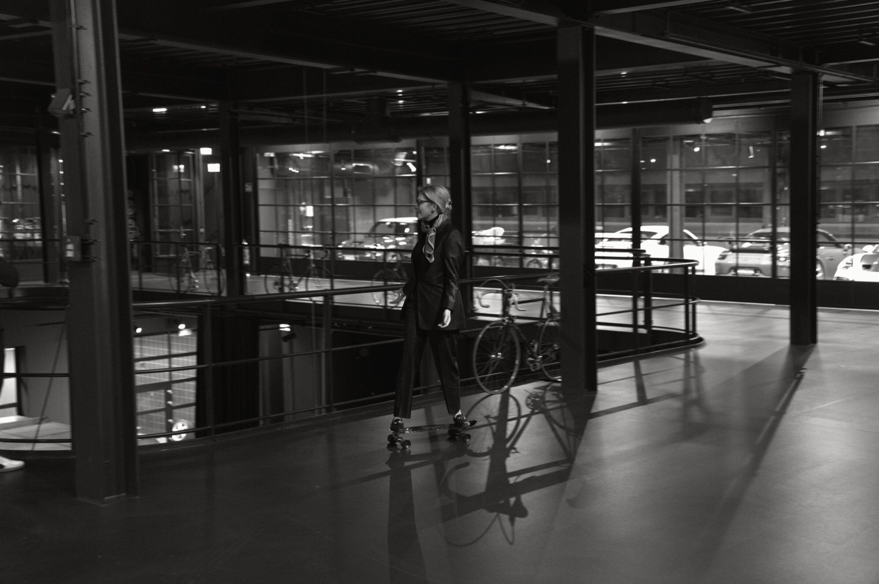 A guest moving through the automotive space on a skateboard.