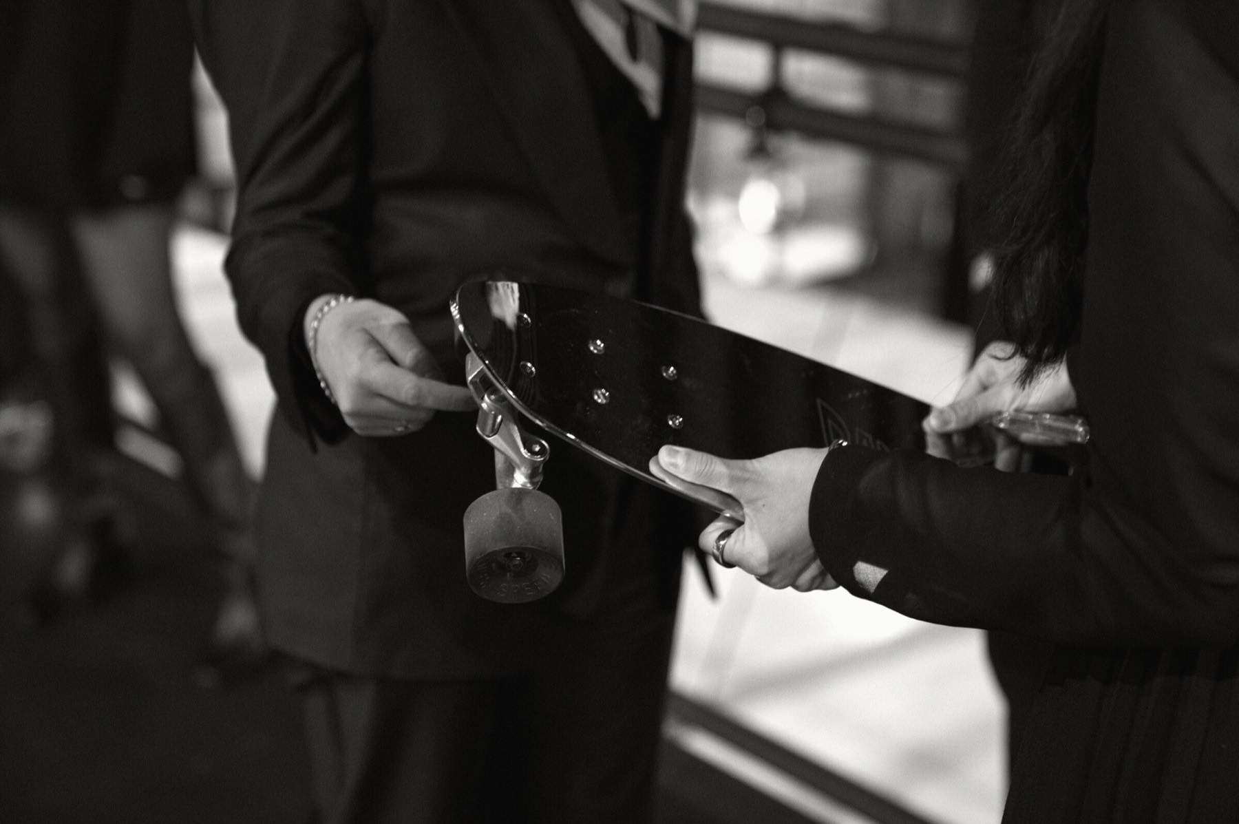 Guests examining a skateboard before dinner.