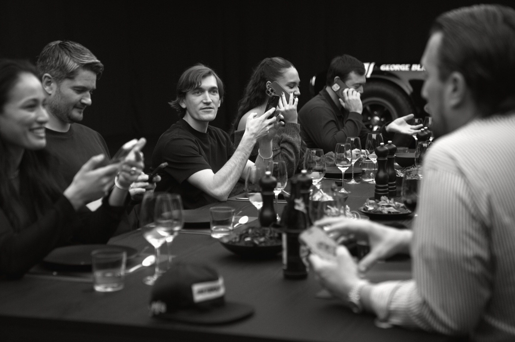 Guests speaking across the dinner table.