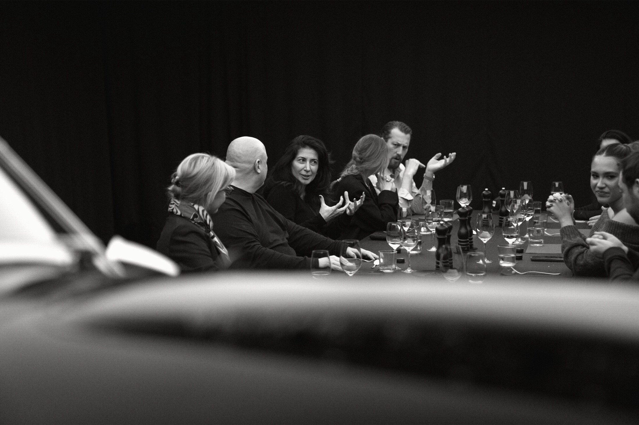Guests in close conversation around the ten-seat dinner table.