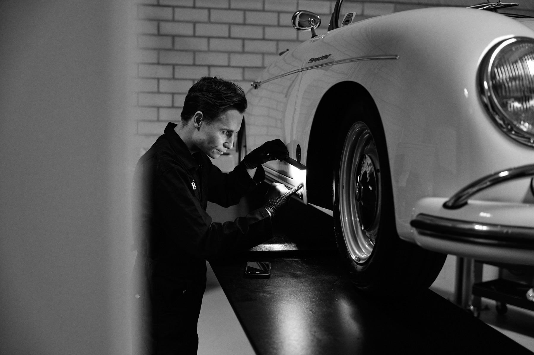 KUKUK engineer examining a classic vehicle